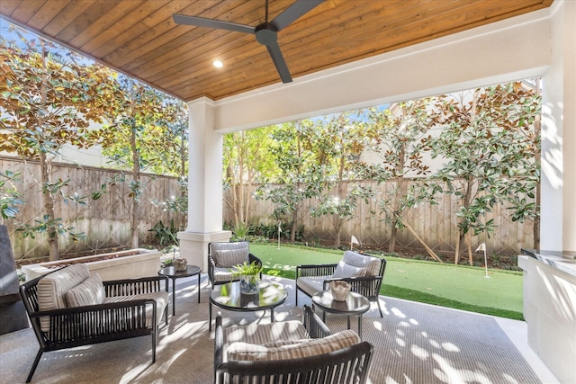 view of patio with an outdoor living space and ceiling fan