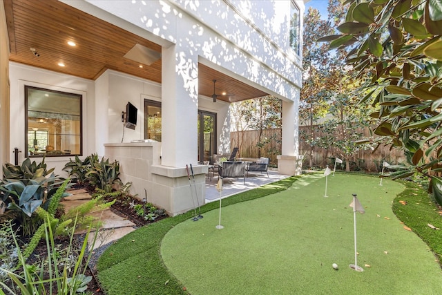 exterior space featuring ceiling fan and a patio area