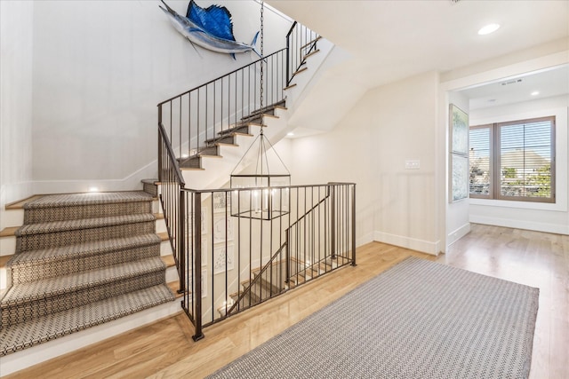 staircase with wood-type flooring