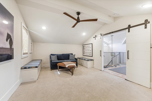 living area with vaulted ceiling with beams, light colored carpet, a barn door, and ceiling fan