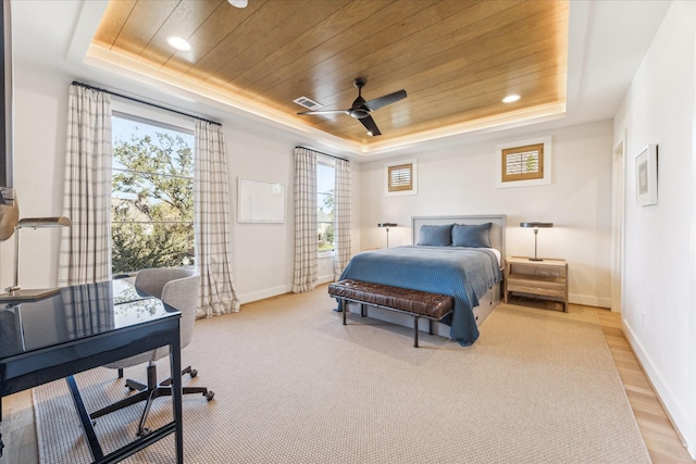 bedroom with wood ceiling, ceiling fan, a raised ceiling, and light wood-type flooring