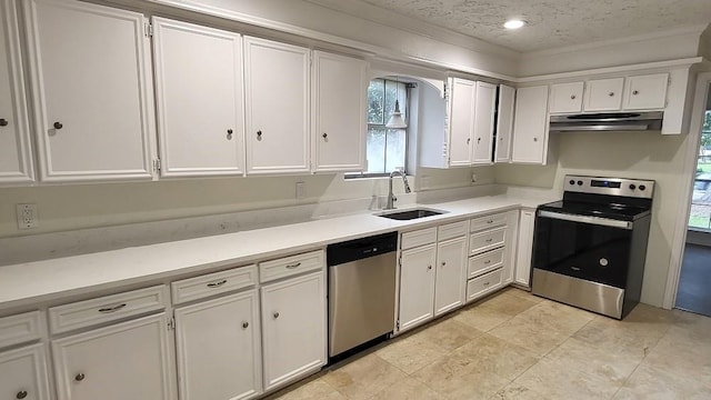 kitchen featuring stainless steel appliances, white cabinetry, and sink