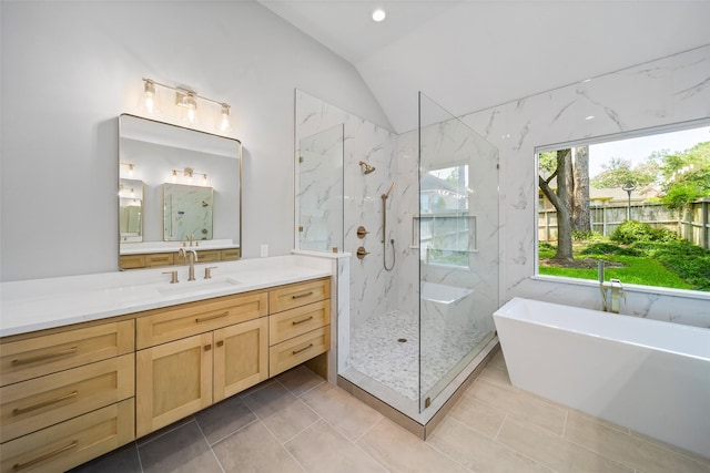 bathroom with vanity, tile patterned flooring, lofted ceiling, and shower with separate bathtub