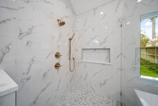 bathroom with plenty of natural light and tiled shower