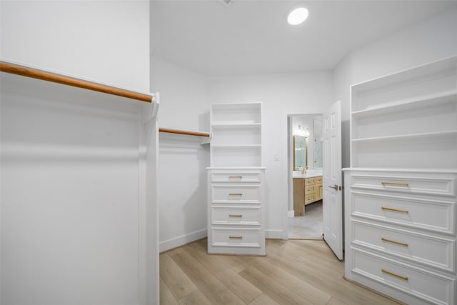 spacious closet with sink and light wood-type flooring