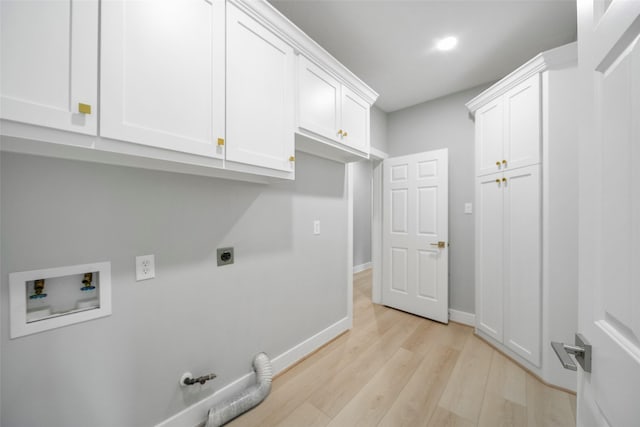 laundry room with hookup for a gas dryer, cabinets, hookup for a washing machine, hookup for an electric dryer, and light wood-type flooring