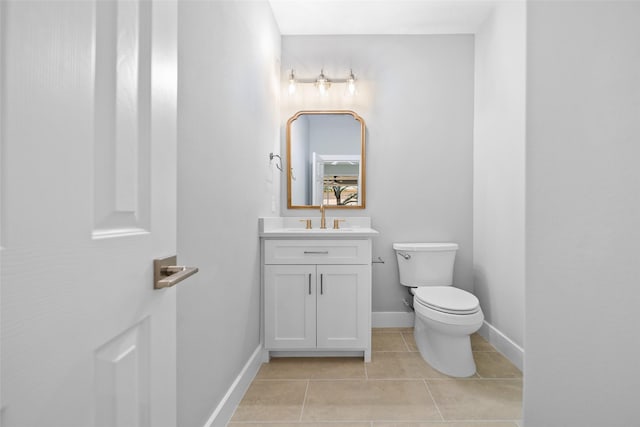 bathroom with tile patterned flooring, vanity, and toilet