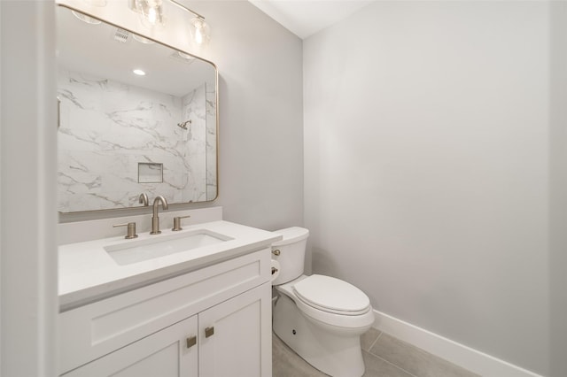 bathroom featuring vanity, tile patterned flooring, and toilet