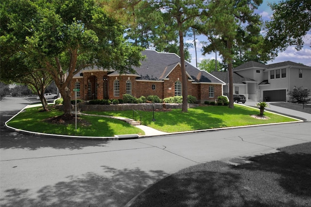 view of front of house with a garage and a front lawn