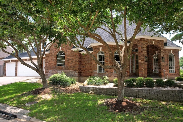 view of front of property featuring a garage and a front lawn