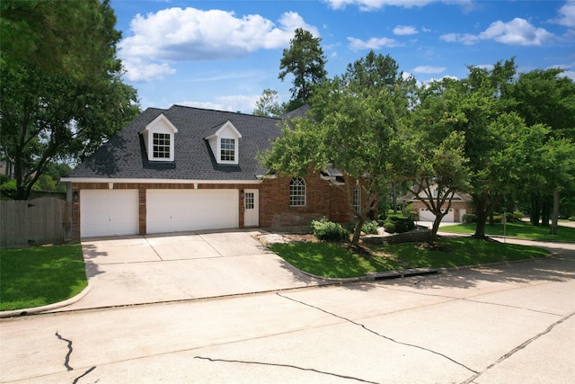 view of front facade featuring a garage and a front lawn