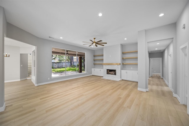 unfurnished living room with ceiling fan and light hardwood / wood-style floors