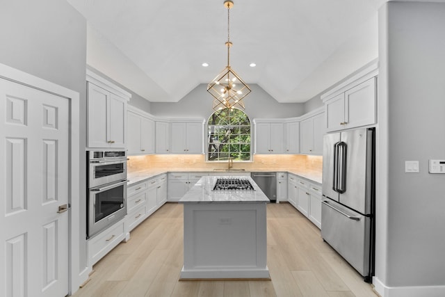 kitchen with stainless steel appliances, a center island, and white cabinets