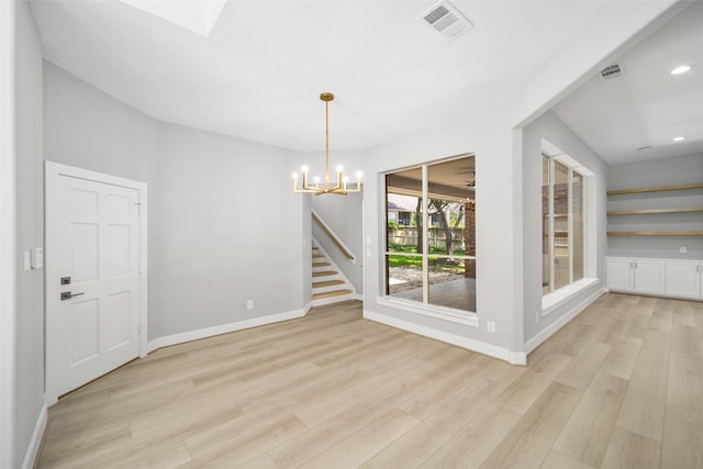 unfurnished dining area featuring a notable chandelier and light wood-type flooring