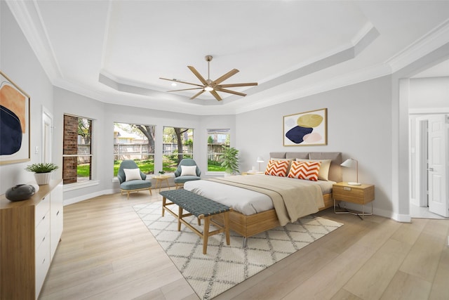 bedroom featuring a raised ceiling, ornamental molding, and light hardwood / wood-style floors