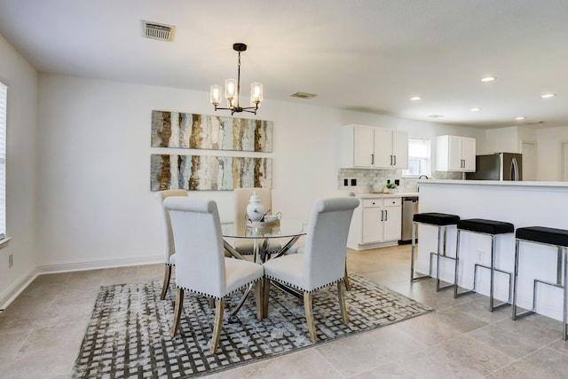 dining space with a notable chandelier