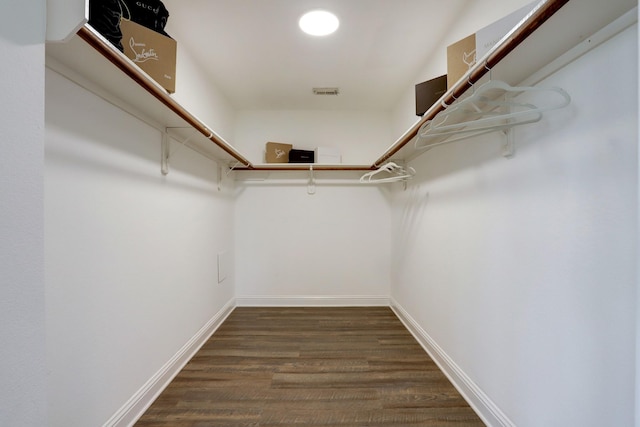 spacious closet featuring dark hardwood / wood-style floors