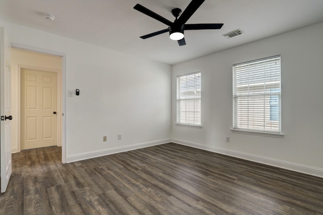 unfurnished room featuring dark wood-type flooring and ceiling fan