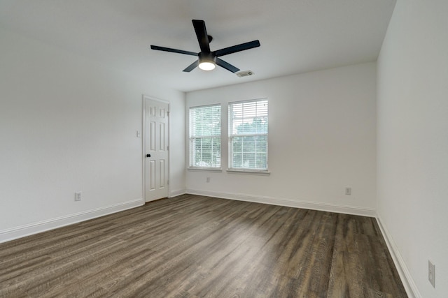 empty room with dark wood-type flooring and ceiling fan