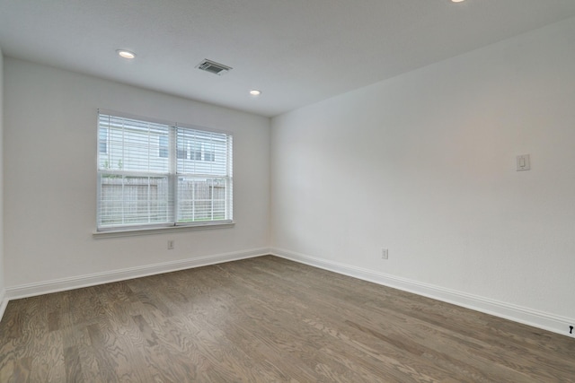 unfurnished room with dark hardwood / wood-style floors