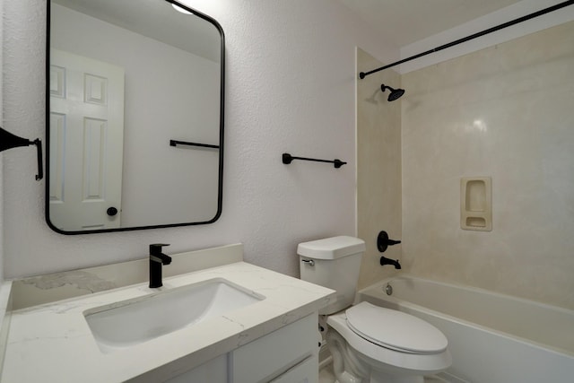 full bathroom with vanity, tiled shower / bath combo, and toilet