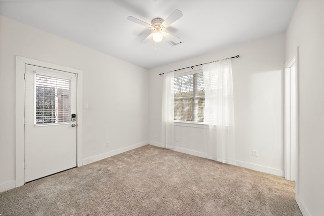 unfurnished room with ceiling fan and light colored carpet