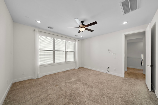 unfurnished bedroom featuring ceiling fan and light carpet