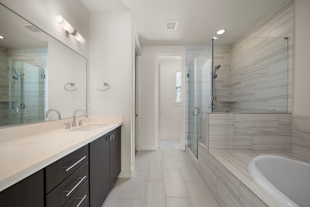 bathroom with vanity and separate shower and tub