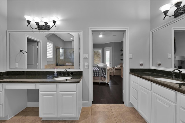 bathroom with vanity, an enclosed shower, and tile patterned floors