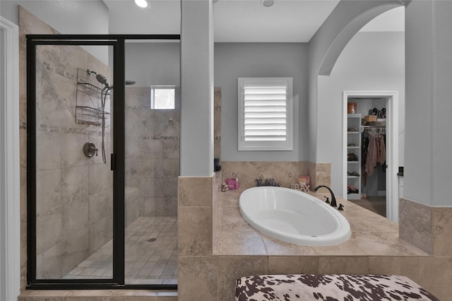 bathroom with shower with separate bathtub