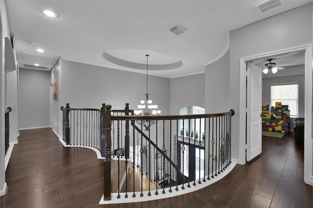 corridor with dark hardwood / wood-style flooring, a notable chandelier, and crown molding