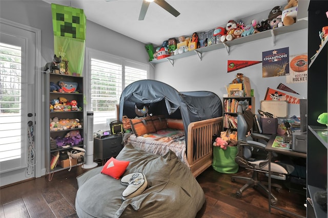 bedroom with ceiling fan and dark hardwood / wood-style flooring