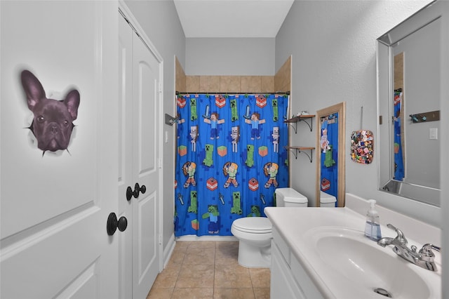 bathroom with vanity, a shower with shower curtain, tile patterned floors, and toilet