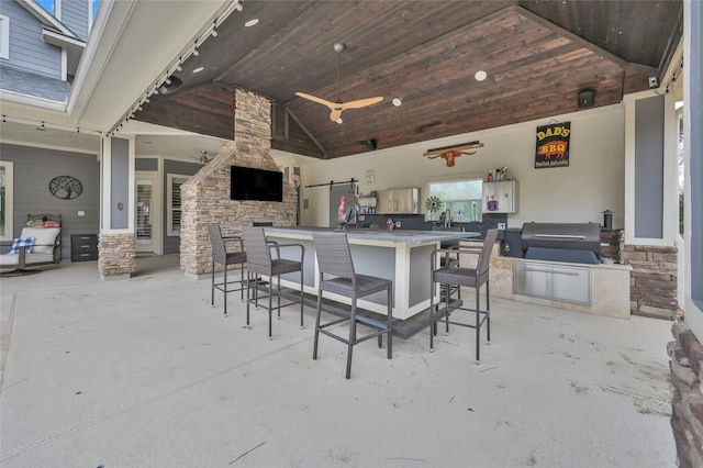 view of patio / terrace with a bar and ceiling fan