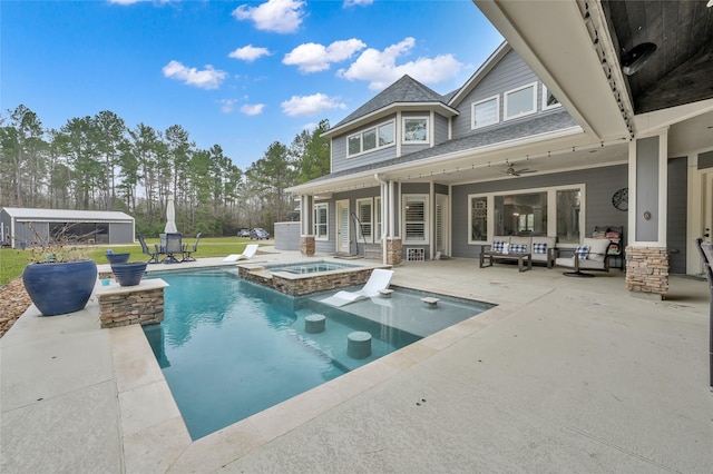 view of pool with an outdoor hangout area, a patio area, and an in ground hot tub