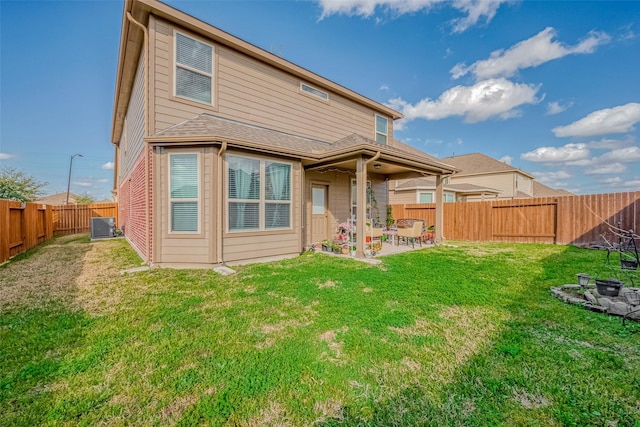 back of house featuring a patio, central AC unit, and a lawn