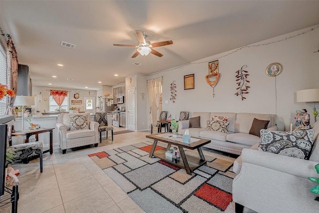 tiled living room featuring ceiling fan