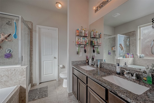 full bathroom featuring tile patterned flooring, shower with separate bathtub, vanity, and toilet