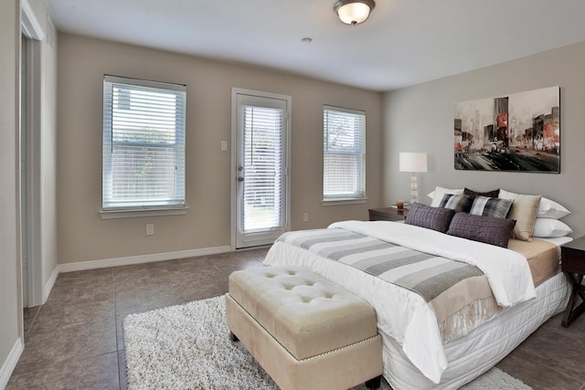 bedroom with light tile patterned floors and access to exterior