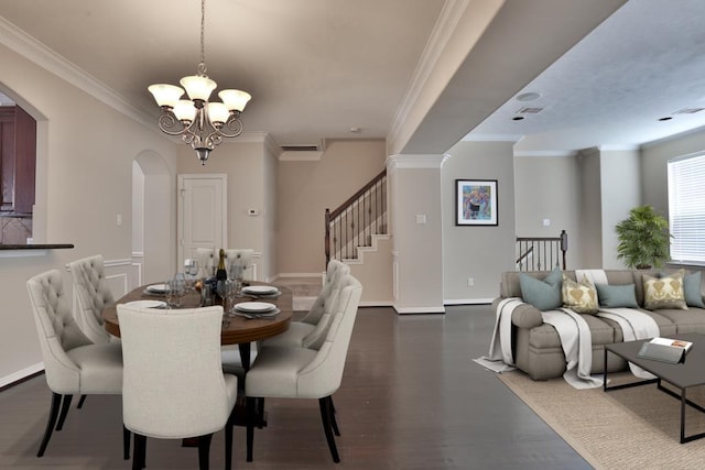 dining space with a notable chandelier, ornamental molding, and dark hardwood / wood-style floors