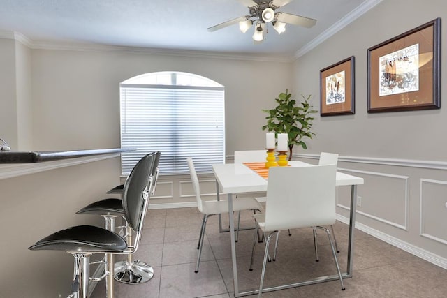 dining room featuring ornamental molding, ceiling fan, and light tile patterned flooring