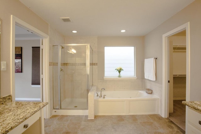 bathroom featuring vanity, tile patterned flooring, and shower with separate bathtub