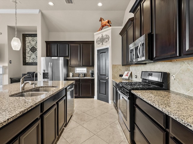 kitchen with dark brown cabinetry, sink, decorative light fixtures, and stainless steel appliances