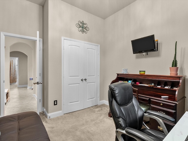 office space featuring a high ceiling and light colored carpet