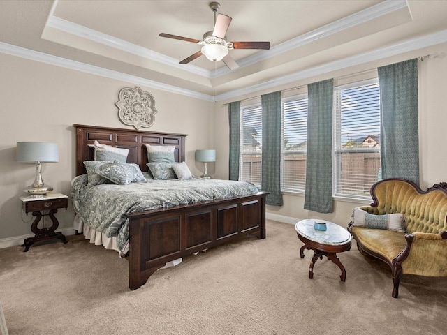 bedroom with crown molding, light colored carpet, a raised ceiling, and ceiling fan