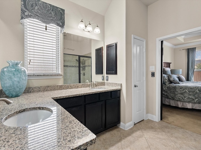 bathroom with tile patterned floors, vanity, and a shower with door