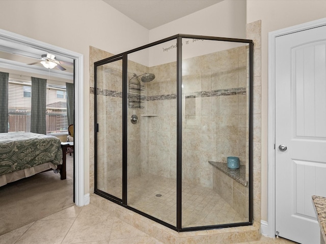 bathroom with tile patterned flooring, a shower with shower door, and ceiling fan