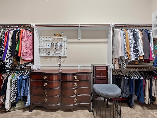 walk in closet featuring light carpet