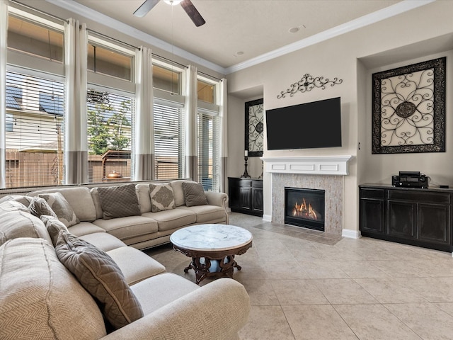 living room with crown molding, light tile patterned floors, and ceiling fan