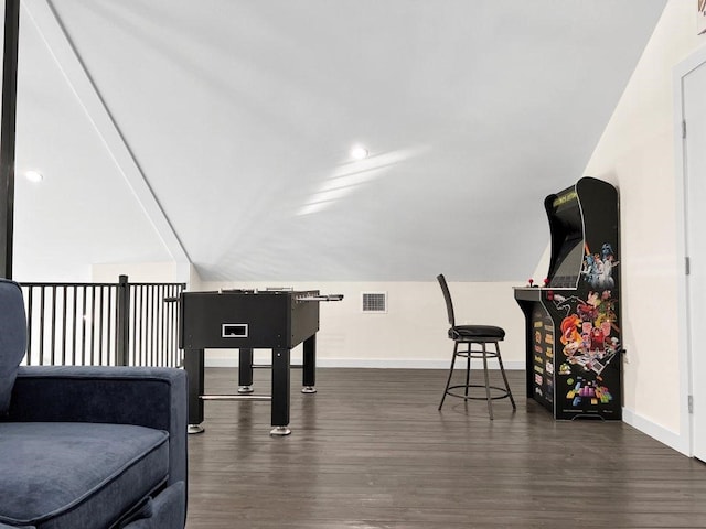 sitting room with dark hardwood / wood-style flooring and vaulted ceiling